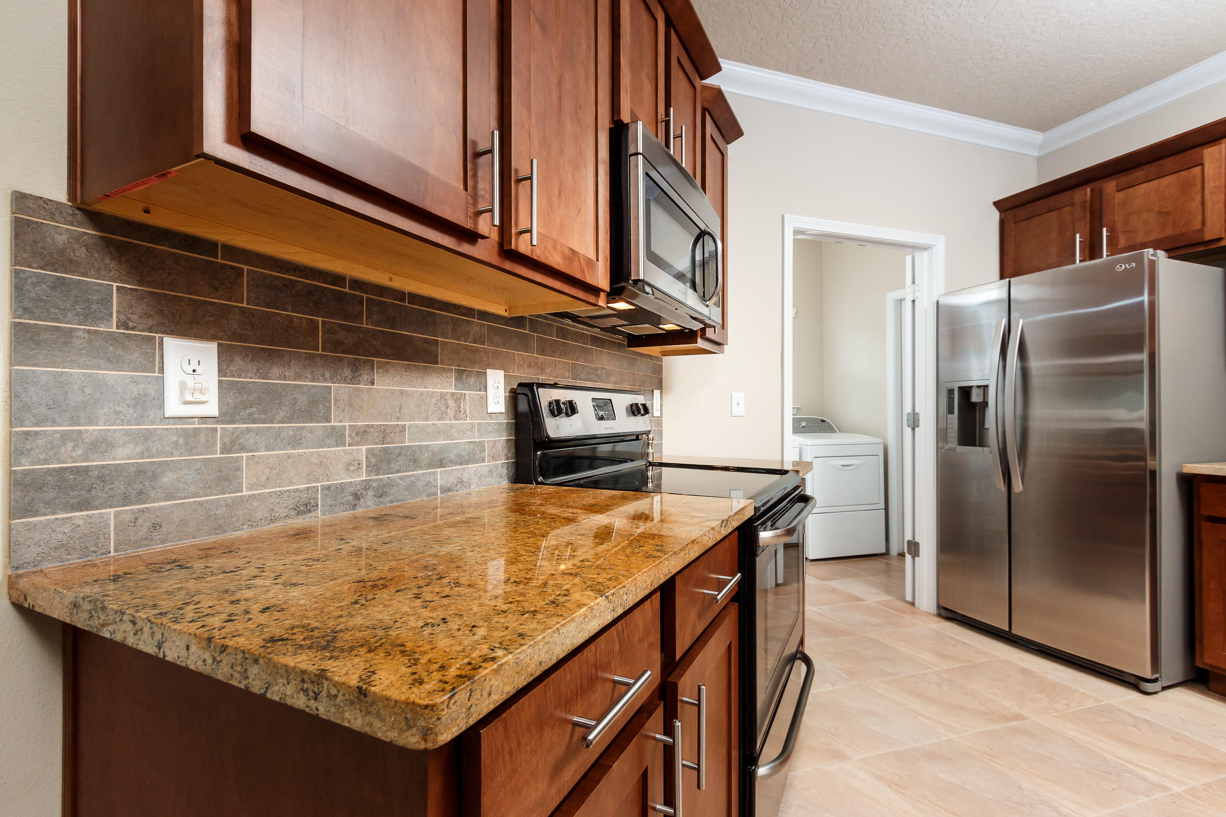 4600 Hermosa Road Crestview, FL 32539 - Photo 6 of 40 a kitchen with stainless steel appliances granite countertop a sink and a refrigerator