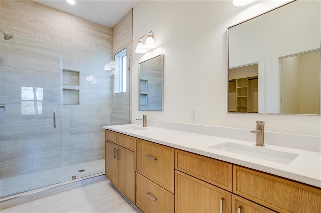 1507 Elk Creek Road Dallas, TX 75253 - Photo 18 of 40 a bathroom with a double vanity sink mirror and shower