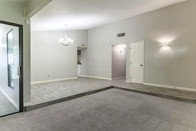an empty room with an entrance to other room