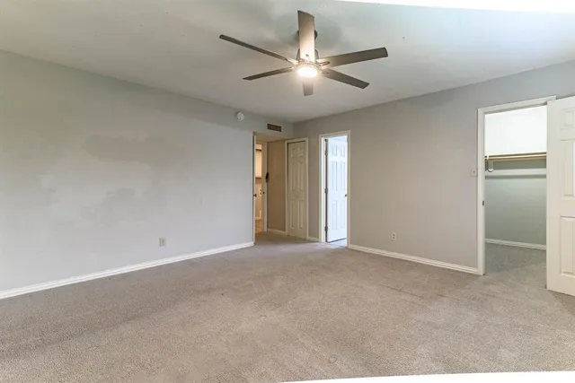 a view of an empty room with a ceiling fan