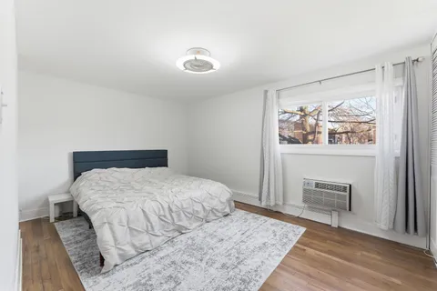 a bedroom with a large bed and a window