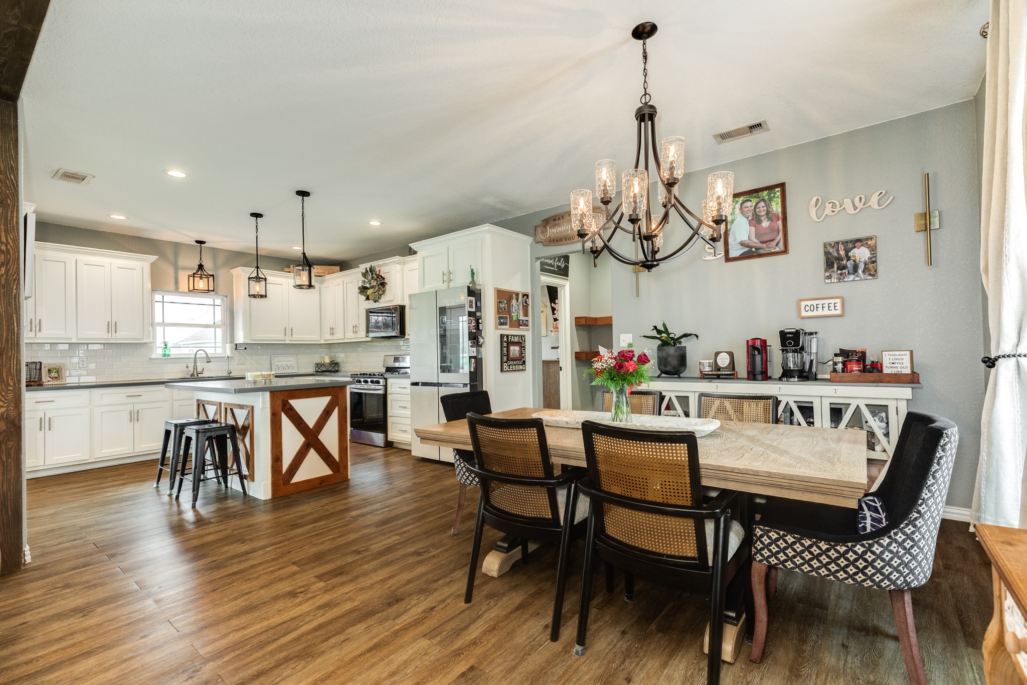613 Winchester Trail Angleton, TX 77515 - Photo 14 of 32 a dining room with wooden floor a chandelier a wooden table and chairs