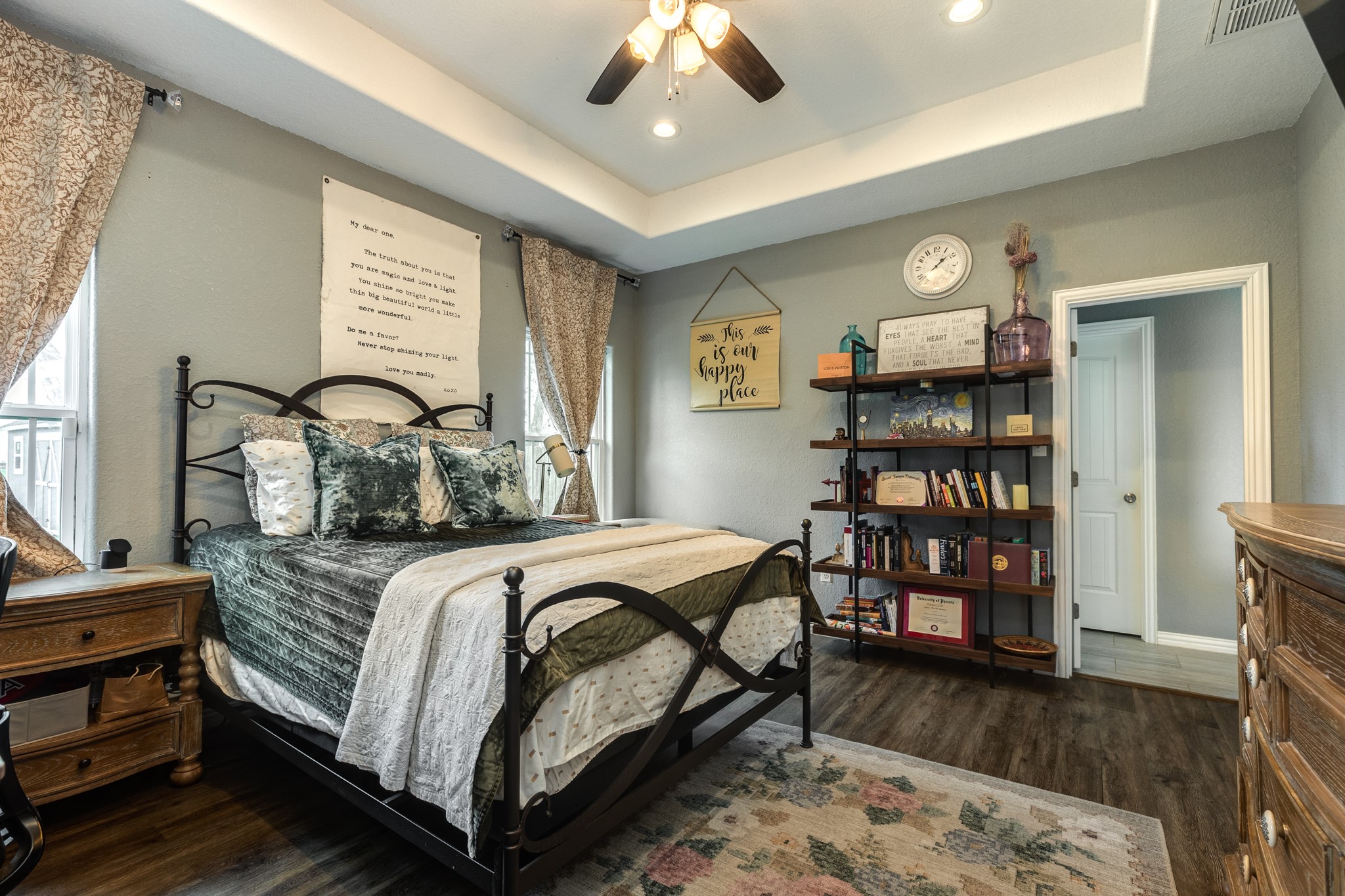 613 Winchester Trail Angleton, TX 77515 - Photo 20 of 32 a bedroom with a bed a dresser and wooden floor