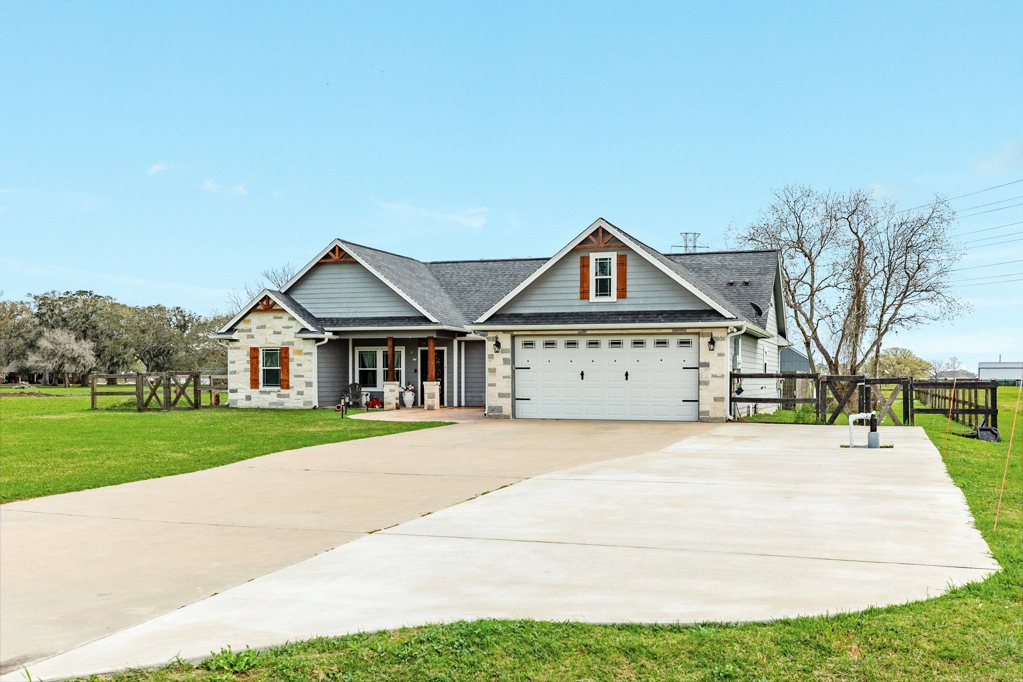 613 Winchester Trail Angleton, TX 77515 - Photo 2 of 32 a front view of a house with a yard and garage
