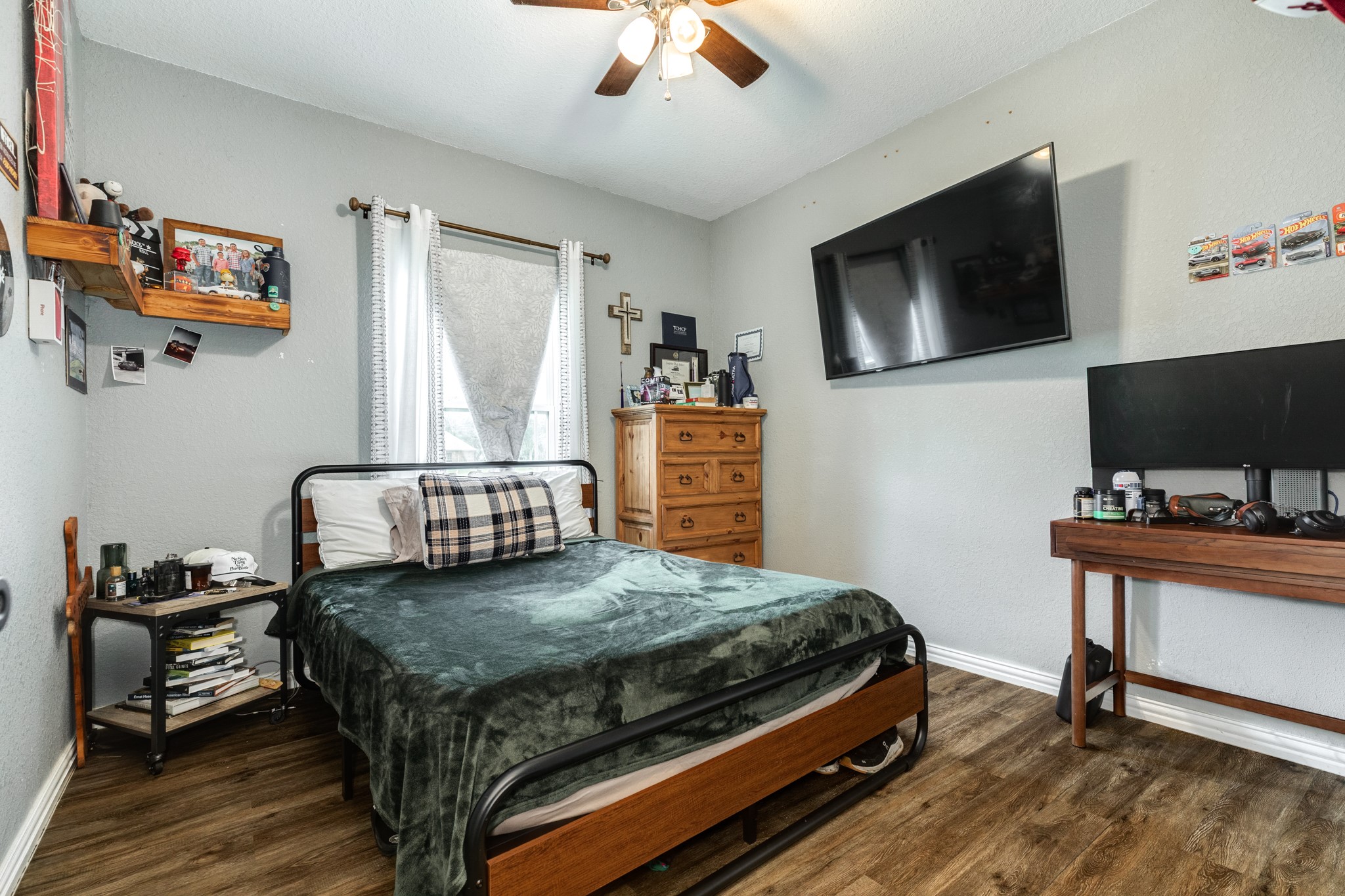 613 Winchester Trail Angleton, TX 77515 - Photo 24 of 32 a bedroom with a bed and a flat screen tv