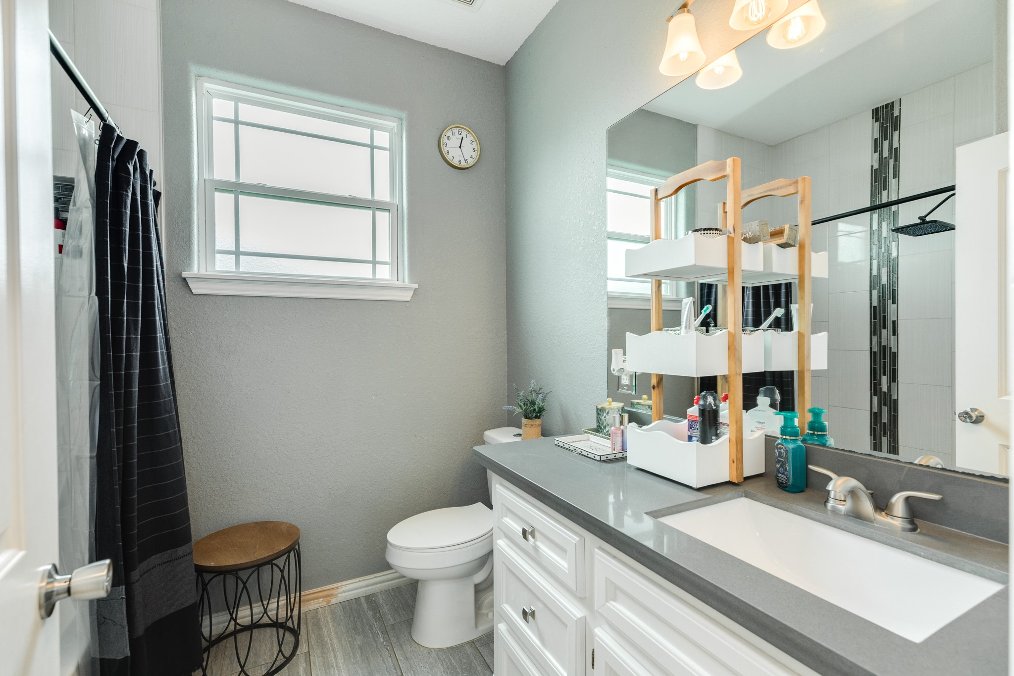 613 Winchester Trail Angleton, TX 77515 - Photo 26 of 32 a bathroom with a granite countertop sink toilet and a mirror