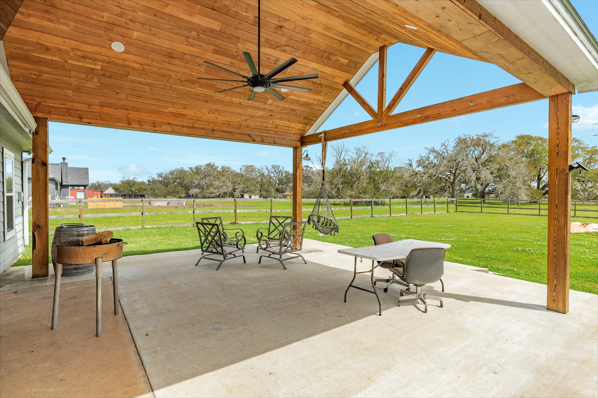 613 Winchester Trail Angleton, TX 77515 - Photo 6 of 32 a garden with a table chairs and ocean view