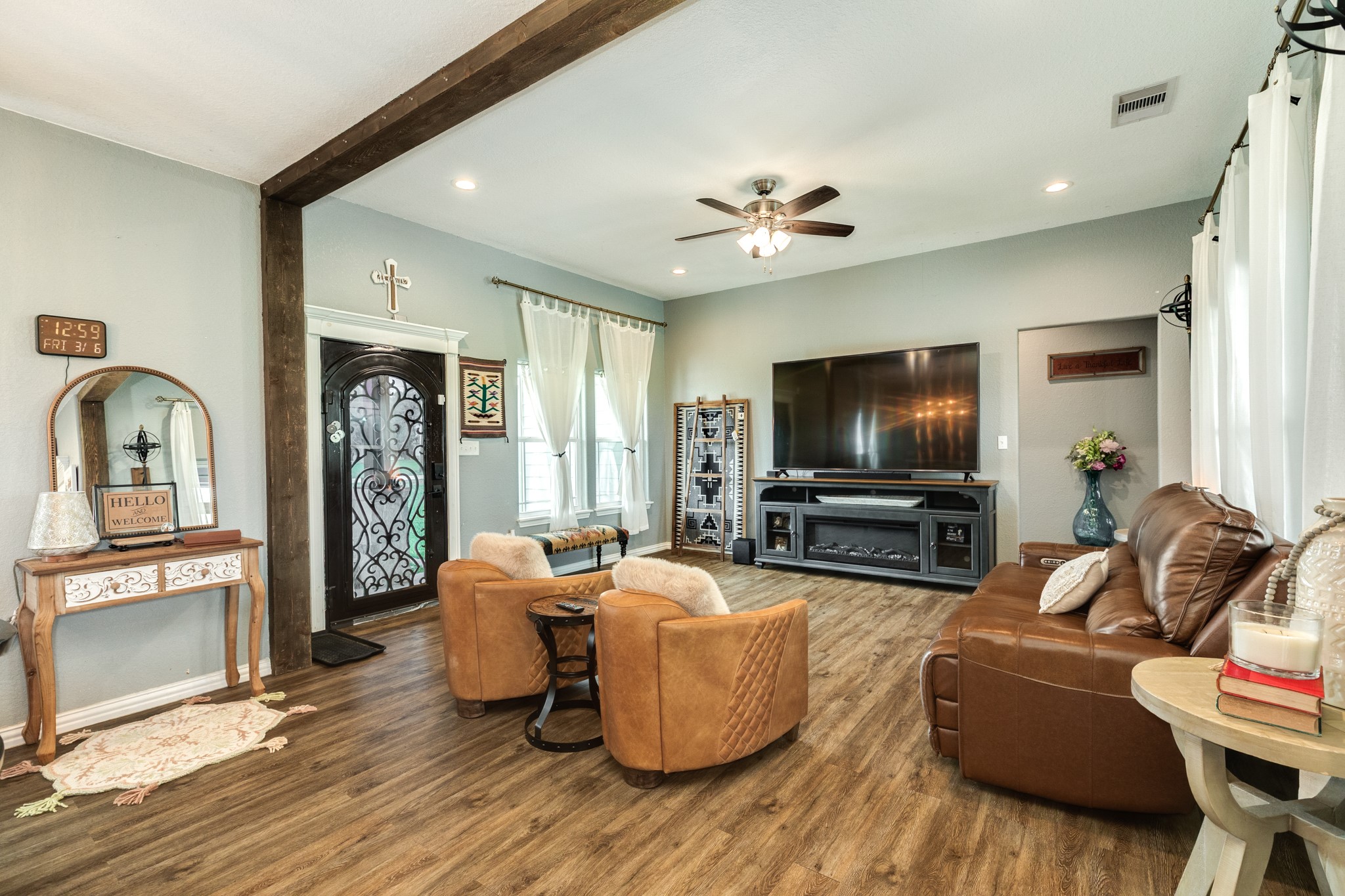613 Winchester Trail Angleton, TX 77515 - Photo 8 of 32 a living room with furniture a flat screen tv and kitchen view