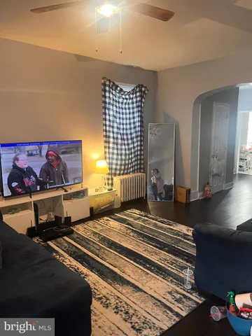 a spacious bedroom with a bed and a painting on the wall