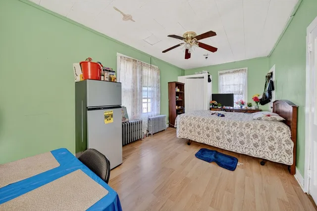a dining room with furniture potted plants and wooden floor