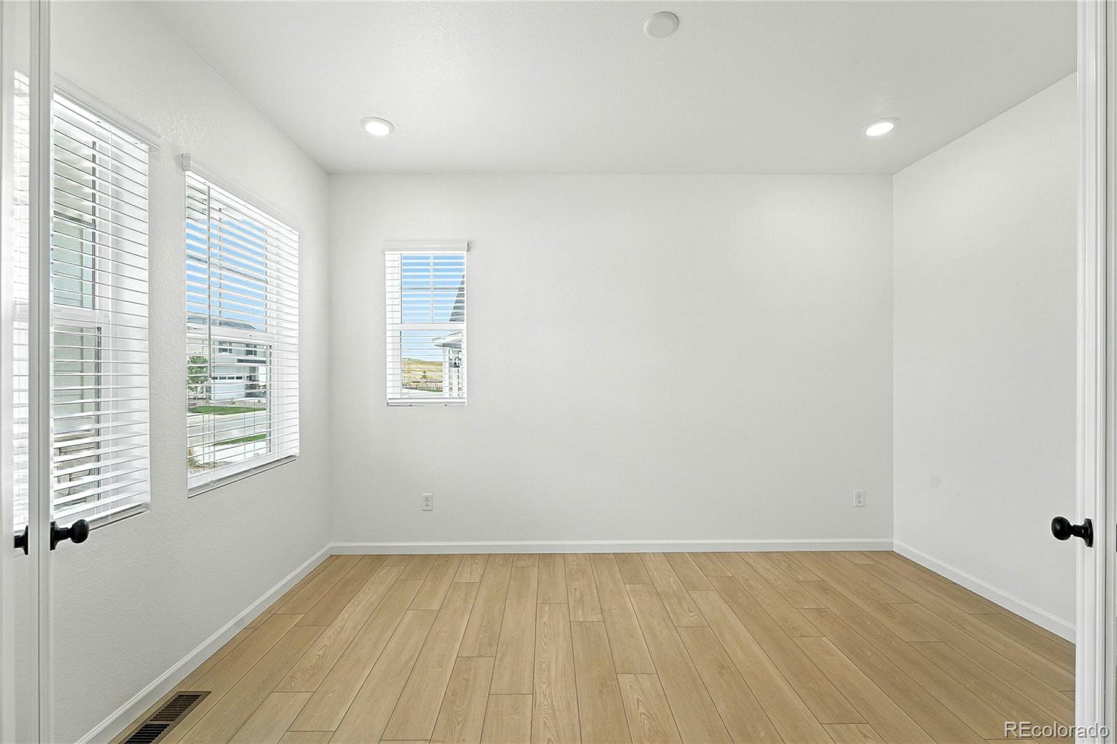 39712 Penn Road Elizabeth, CO 80107 - Photo 11 of 36 an empty room with wooden floor and windows