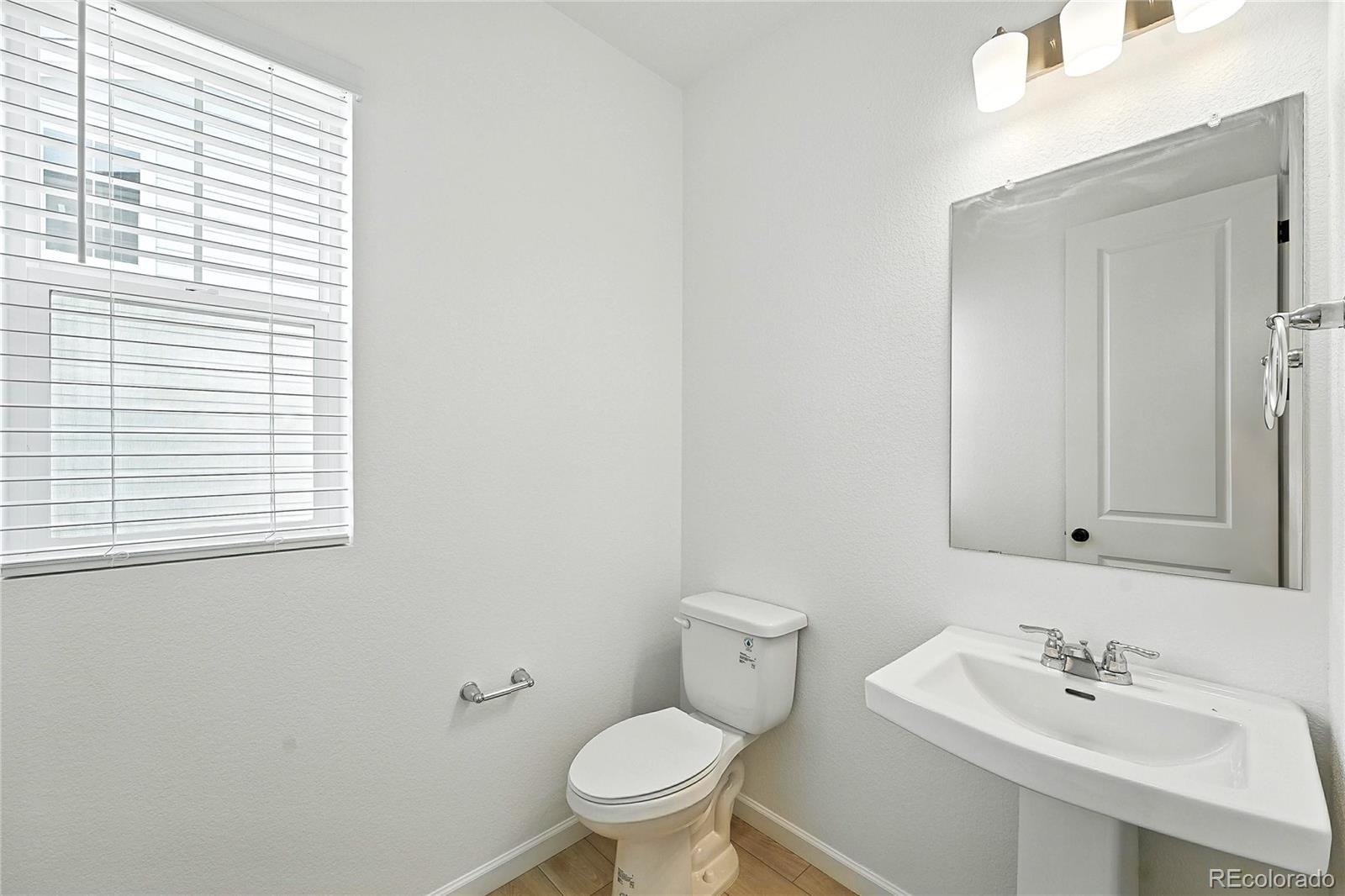 39712 Penn Road Elizabeth, CO 80107 - Photo 12 of 36 a bathroom with a sink mirror and toilet