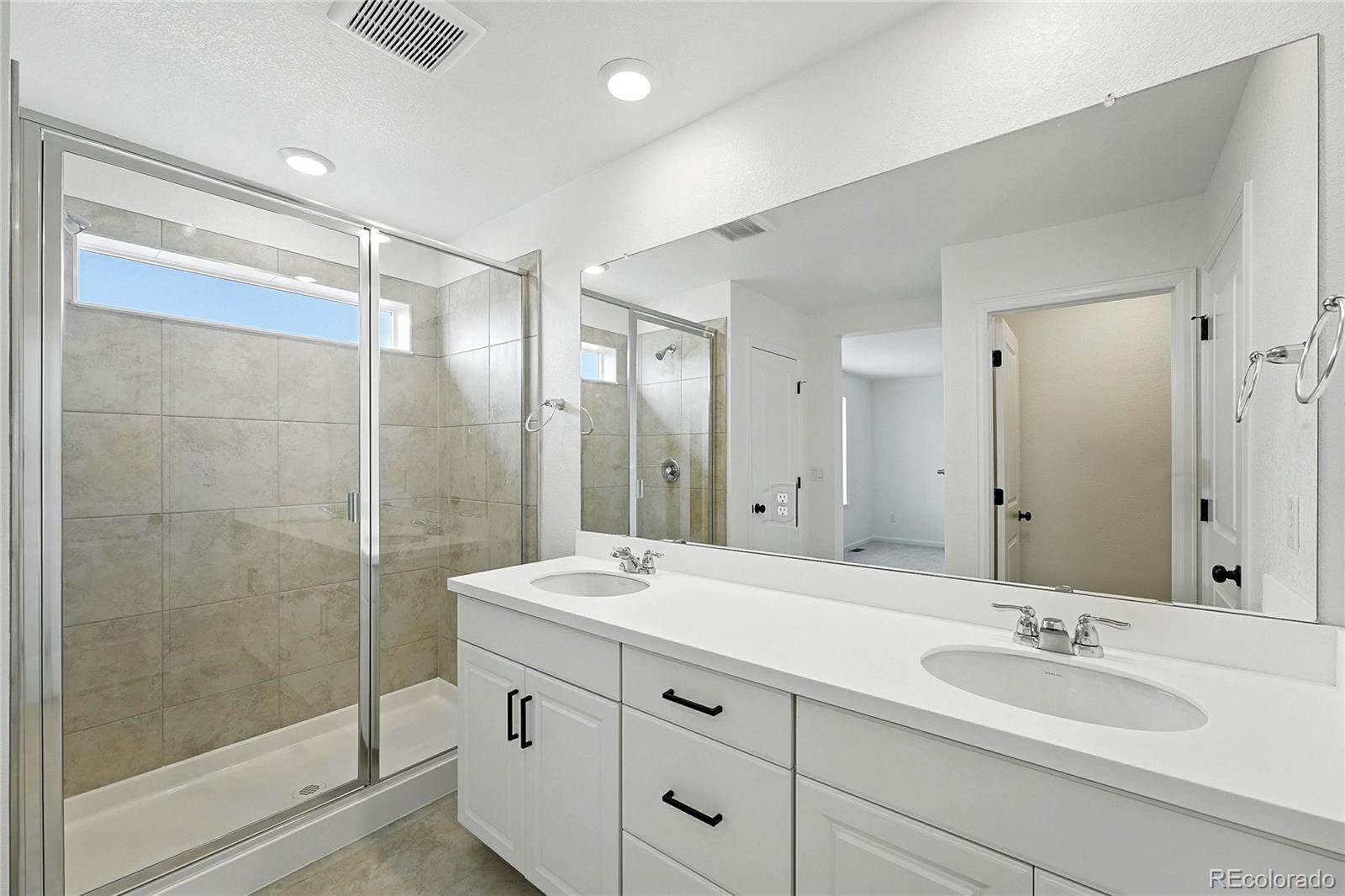 39712 Penn Road Elizabeth, CO 80107 - Photo 22 of 36 a bathroom with a double vanity sink mirror and shower