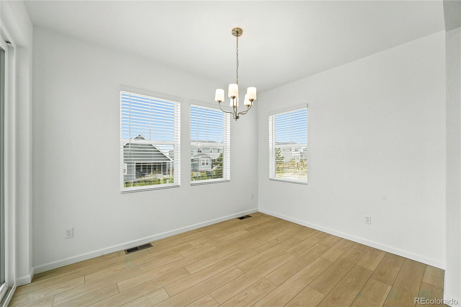 39712 Penn Road Elizabeth, CO 80107 - Photo 4 of 36 an empty room with windows and chandelier