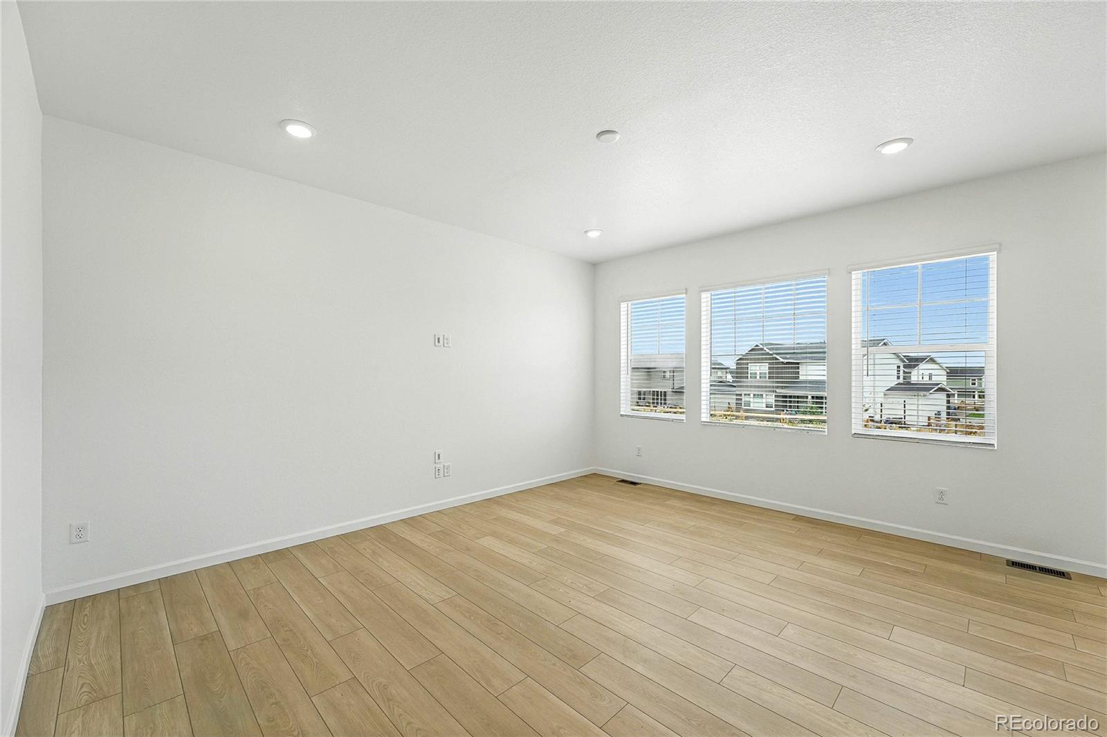 39712 Penn Road Elizabeth, CO 80107 - Photo 6 of 36 an empty room with wooden floor and windows