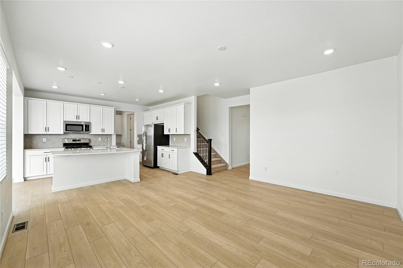 39712 Penn Road Elizabeth, CO 80107 - Photo 7 of 36 a view of kitchen with stainless steel appliances refrigerator oven and white cabinets