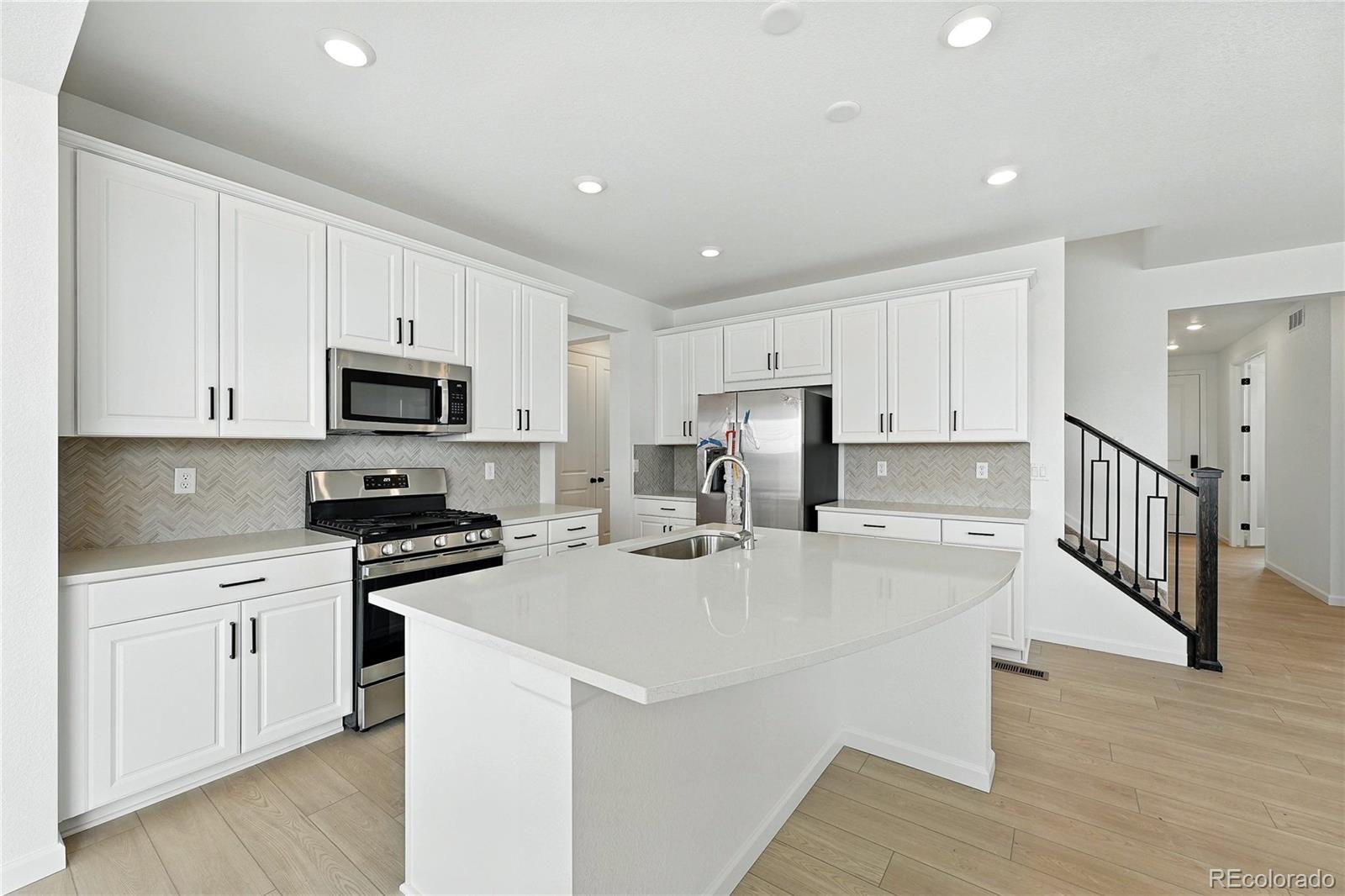 39712 Penn Road Elizabeth, CO 80107 - Photo 8 of 36 a kitchen with stainless steel appliances a stove refrigerator sink and cabinets