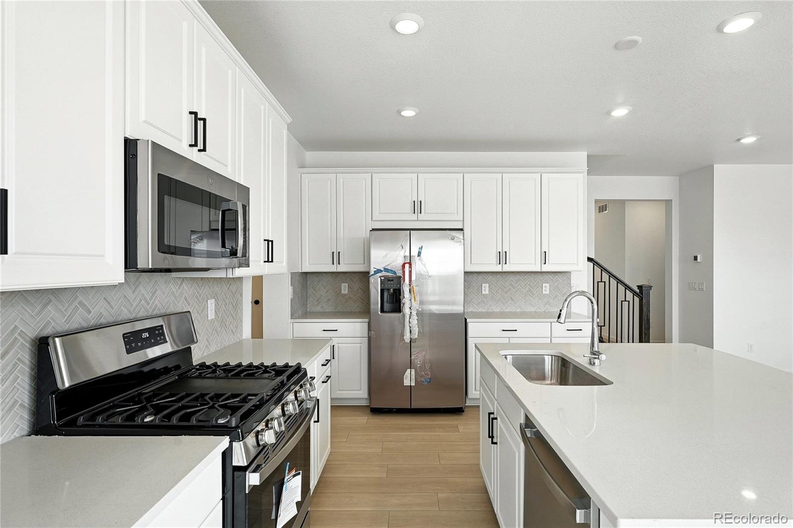 39712 Penn Road Elizabeth, CO 80107 - Photo 9 of 36 a kitchen with stainless steel appliances a stove sink microwave and cabinets