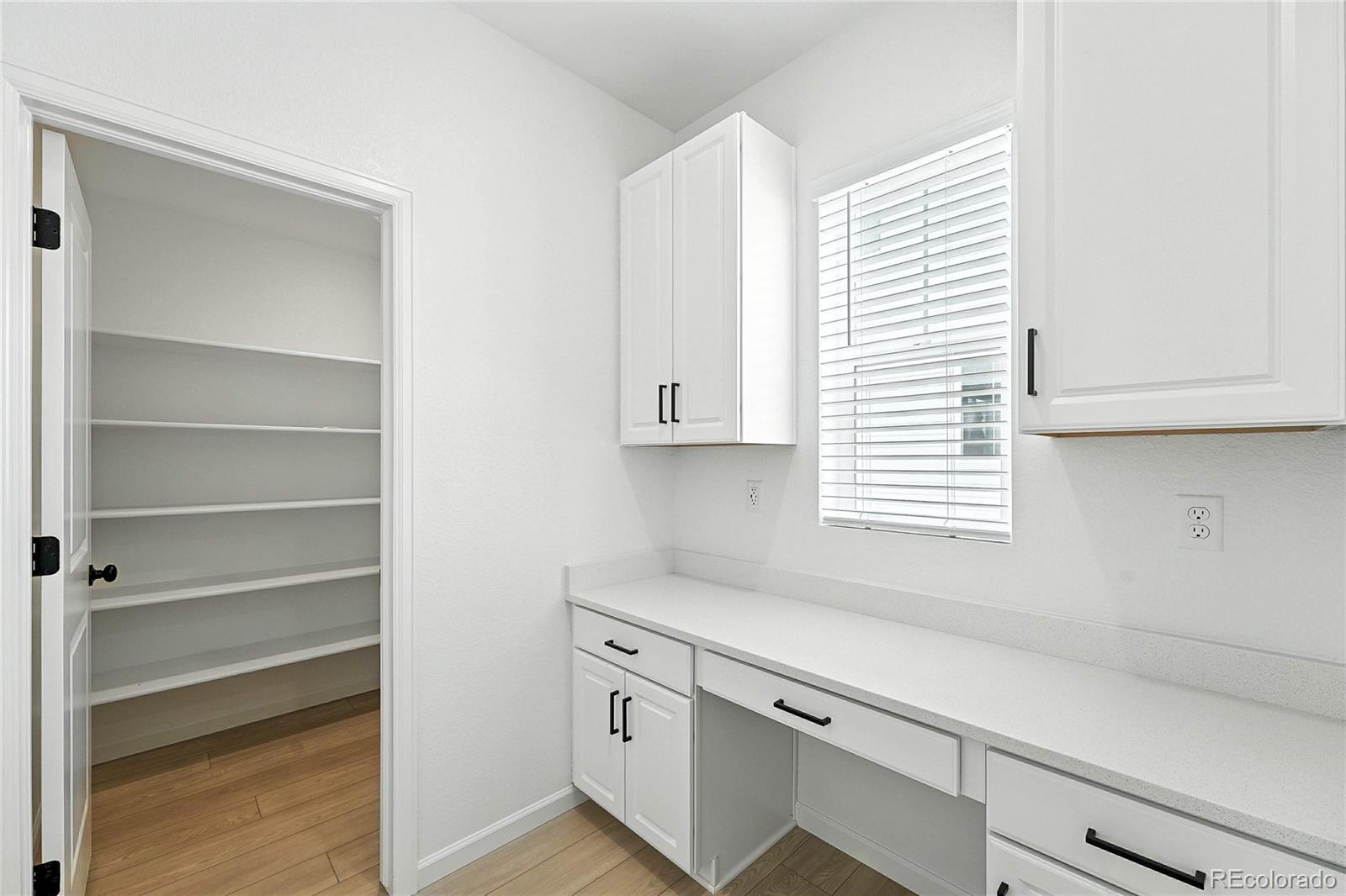 39712 Penn Road Elizabeth, CO 80107 - Photo 10 of 36 a kitchen with white cabinets and a window