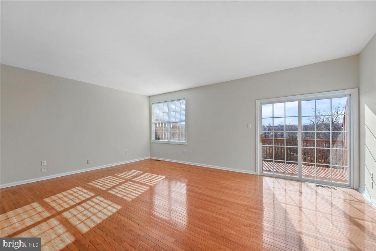 652 Onward Avenue, Unit 56 Phoenixville, PA 19460 - Photo 11 of 35 an empty room with wooden floor and windows