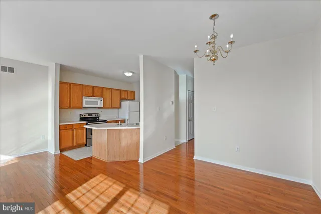 a view of kitchen with sink and refrigerator