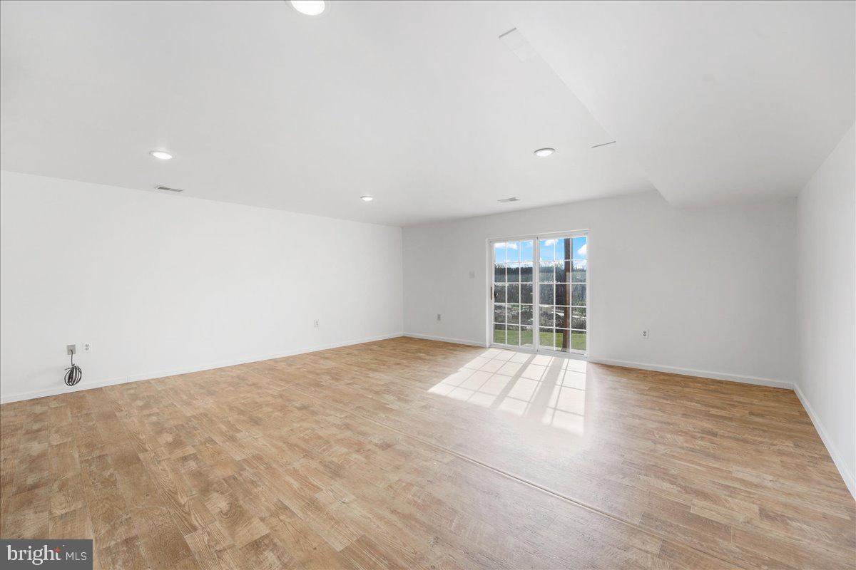 652 Onward Avenue, Unit 56 Phoenixville, PA 19460 - Photo 22 of 35 a view of an empty room with wooden floor and fan
