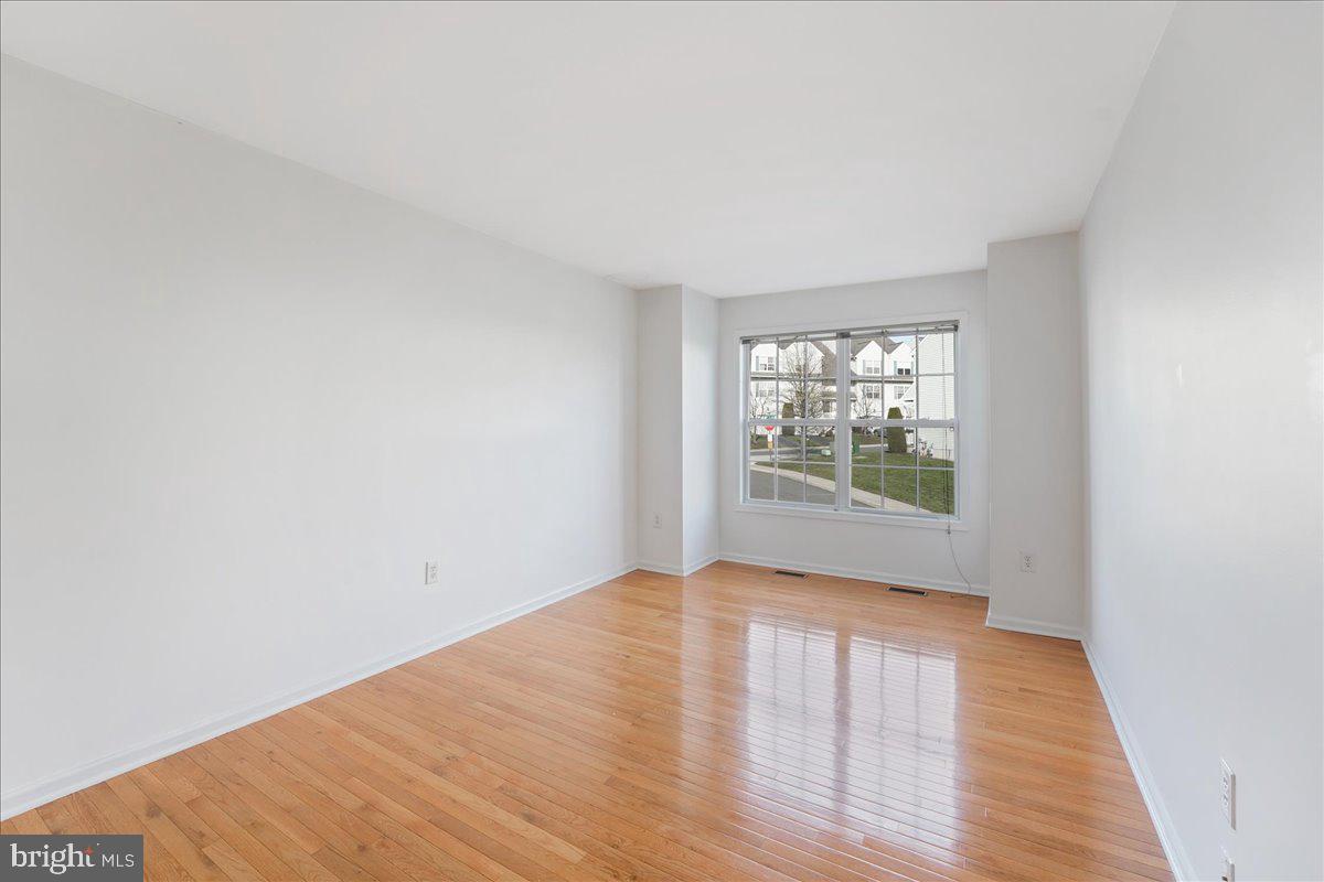 652 Onward Avenue, Unit 56 Phoenixville, PA 19460 - Photo 25 of 35 a view of an empty room with wooden floor and a window