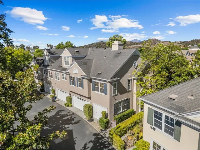 aerial view of a house with a yard and balcony