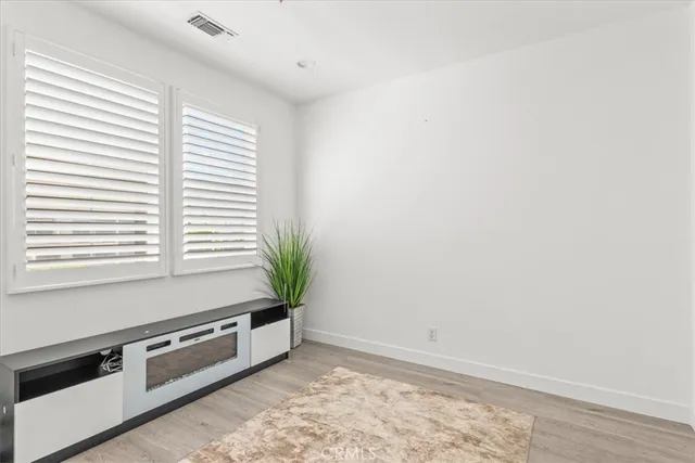 a bathroom with a sink vanity granite toilet and a mirror