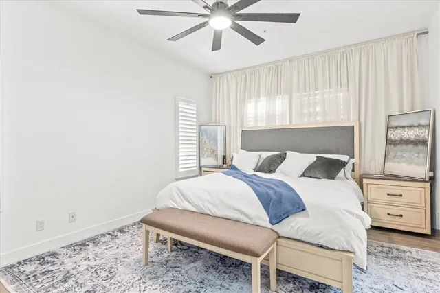 a large bed sitting in a bedroom next to a window