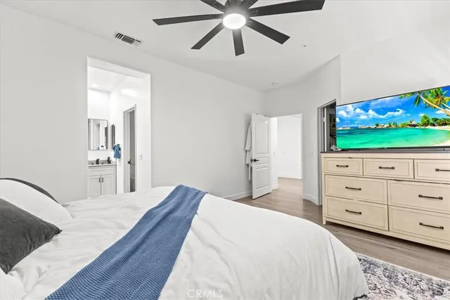 a bathroom with a double vanity sink a large mirror a bathtub and