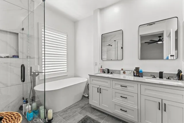 a bathroom with double vanity sink and a mirror
