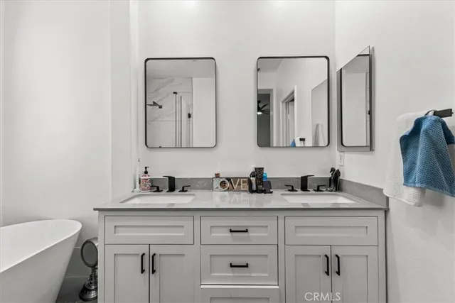 a view of walk in closet with clothes