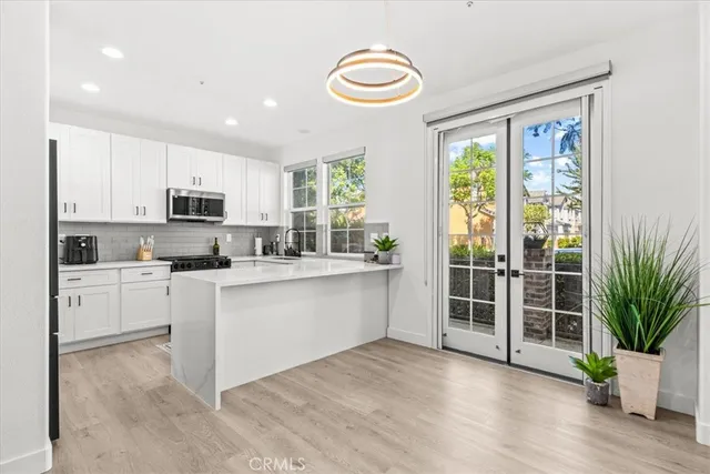 a kitchen with a refrigerator and a sink