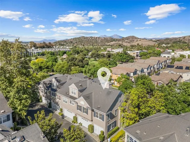 an aerial view of residential houses with outdoor space