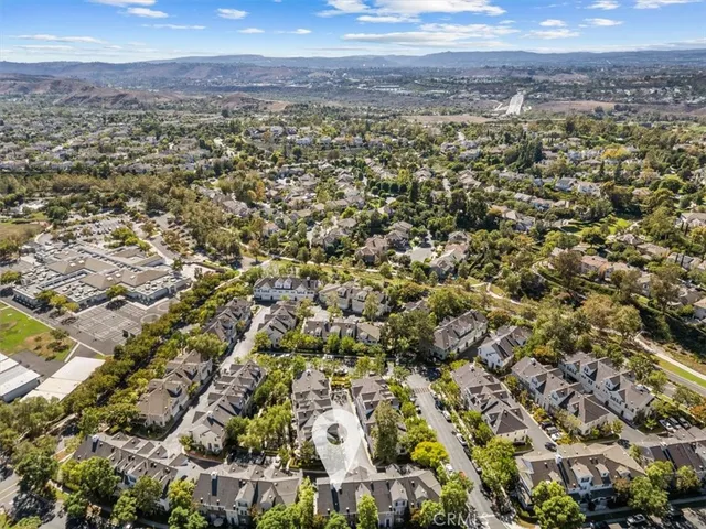 an aerial view of residential houses with city view