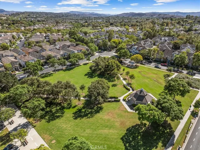 an aerial view of a residential houses with yard