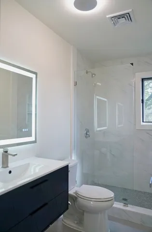 a bathroom with a sink toilet vanity and tub