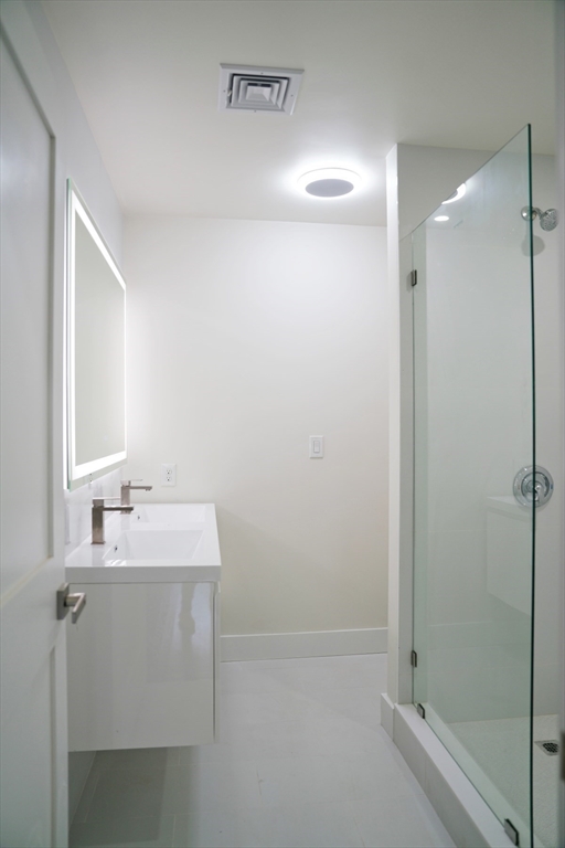 281 Forest Street Arlington, MA 02474 - Photo 16 of 26 a bathroom with a sink and a mirror