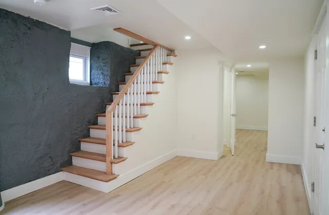 a view of entryway with stairs and wooden floor
