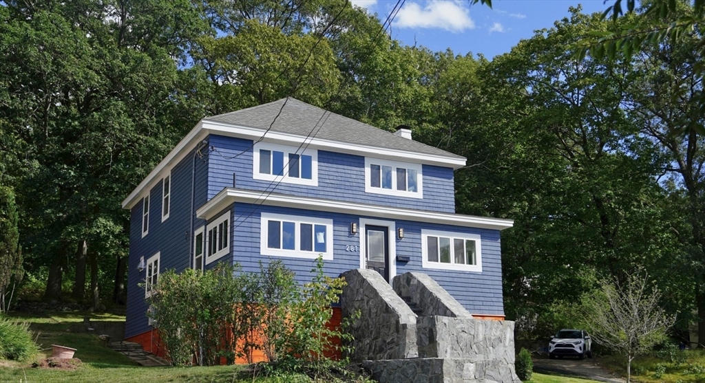 281 Forest Street Arlington, MA 02474 - Photo 2 of 26 a front view of a house with a yard