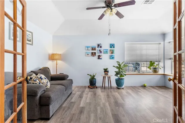 a living room with furniture and wooden floor