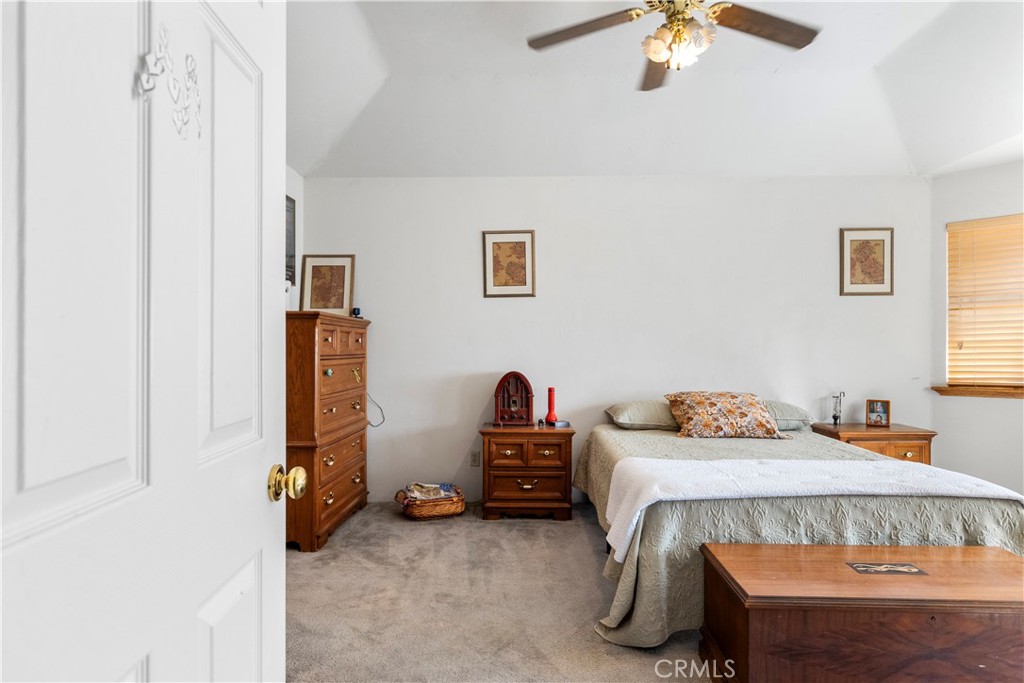 18888 Pellisier Road Tehachapi, CA 93561 - Photo 17 of 43 a bedroom with a bed and a chandelier