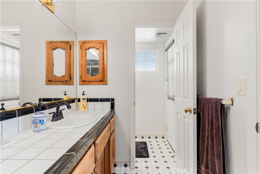 18888 Pellisier Road Tehachapi, CA 93561 - Photo 22 of 43 a bathroom with a sink a mirror and a shower