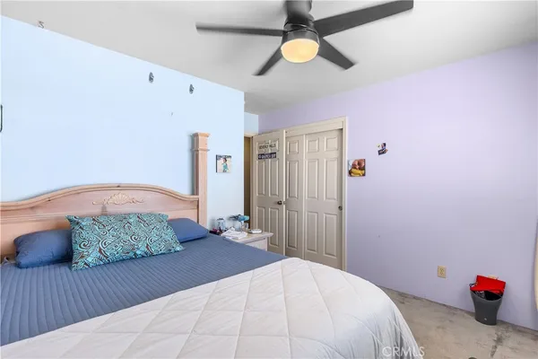 a bedroom with a bed and a dresser