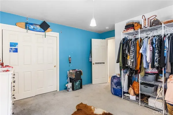 a view of walk in closet with clothes
