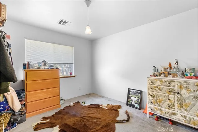 a bedroom with a bed and a tv