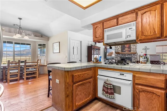 a kitchen with stainless steel appliances granite countertop a stove and cabinets