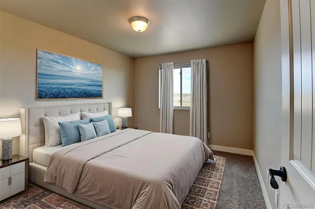 a bedroom with a bed and a painting on the wall