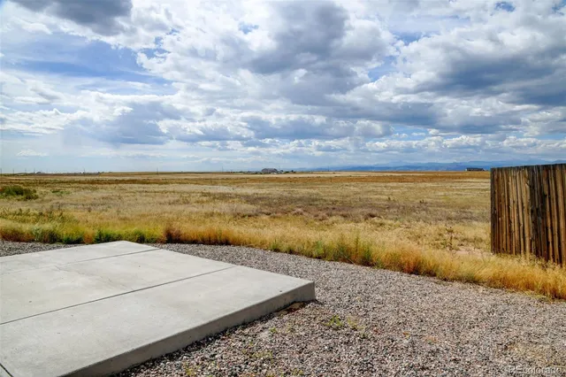 a house with yard and a wooden fence